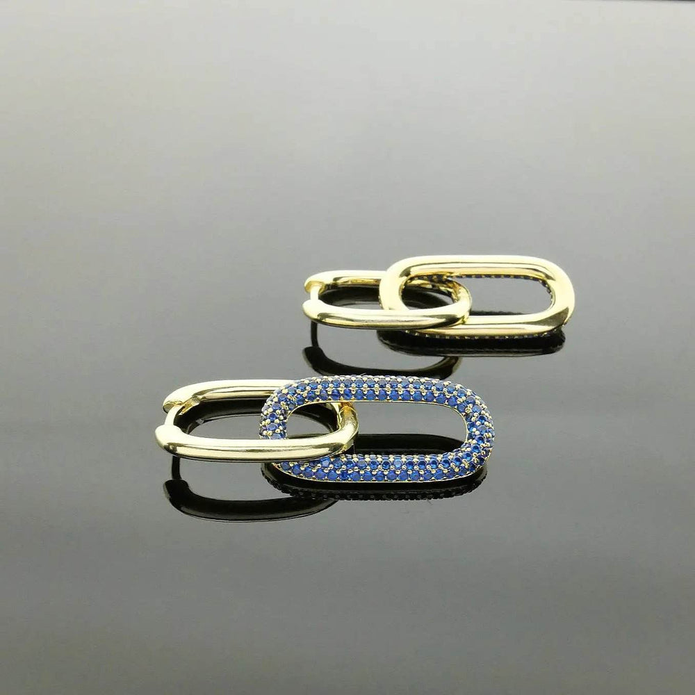 
                      
                        Goudkleurige oorbellen met blauwe zirkonia's - Victoria Valenza
                      
                    