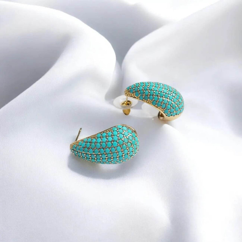 
                      
                        Vergulde druppel oorbellen met turquoise zirkonia's - Victoria Valenza
                      
                    