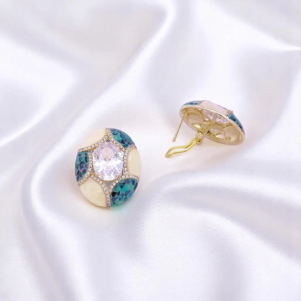 
                      
                        Goudkleurige ovale oorbellen met blauwe parelmoer en zirkonia stenen  Victoria Valenza
                      
                    