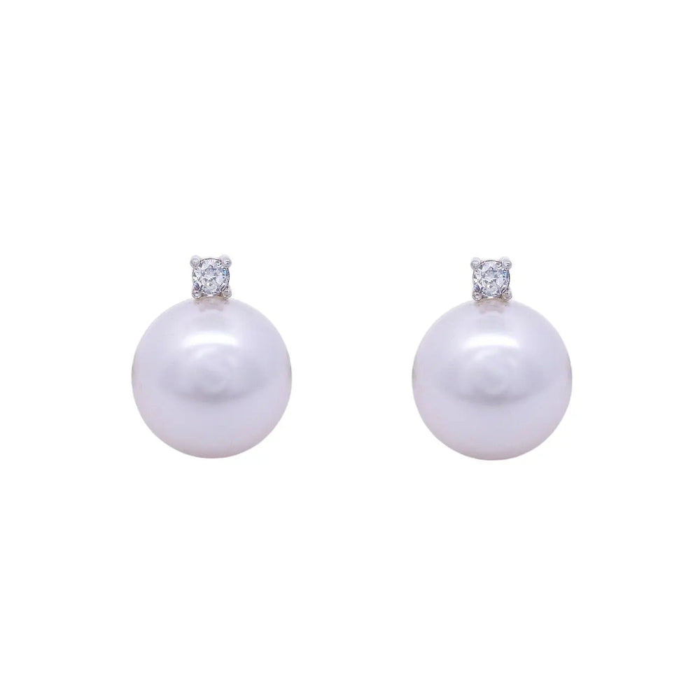 
                      
                        Zilveren clip oorbellen met parels 14 mm en zirkonia stenen.  Victoria Valenza
                      
                    