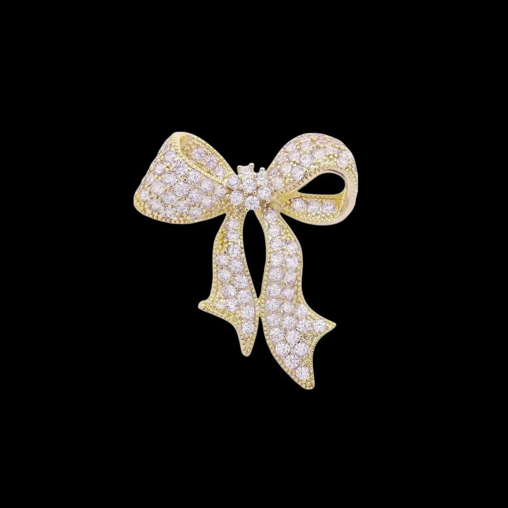 Goudkleurige strik broche met zirkonia stenen  Victoria Valenza