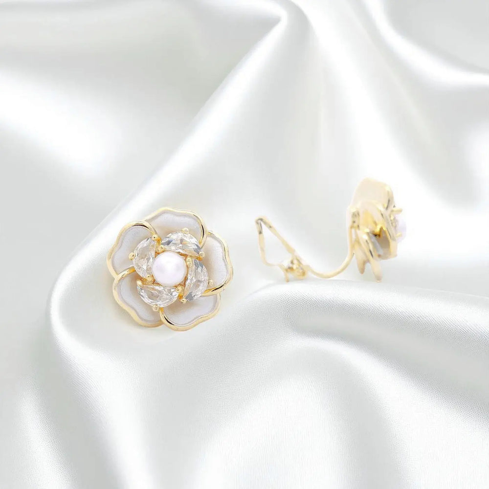 
                      
                        Goudkleurige camellia oorbellen met clipsen met parels, emaille en zirkonia stenen  Victoria Valenza
                      
                    