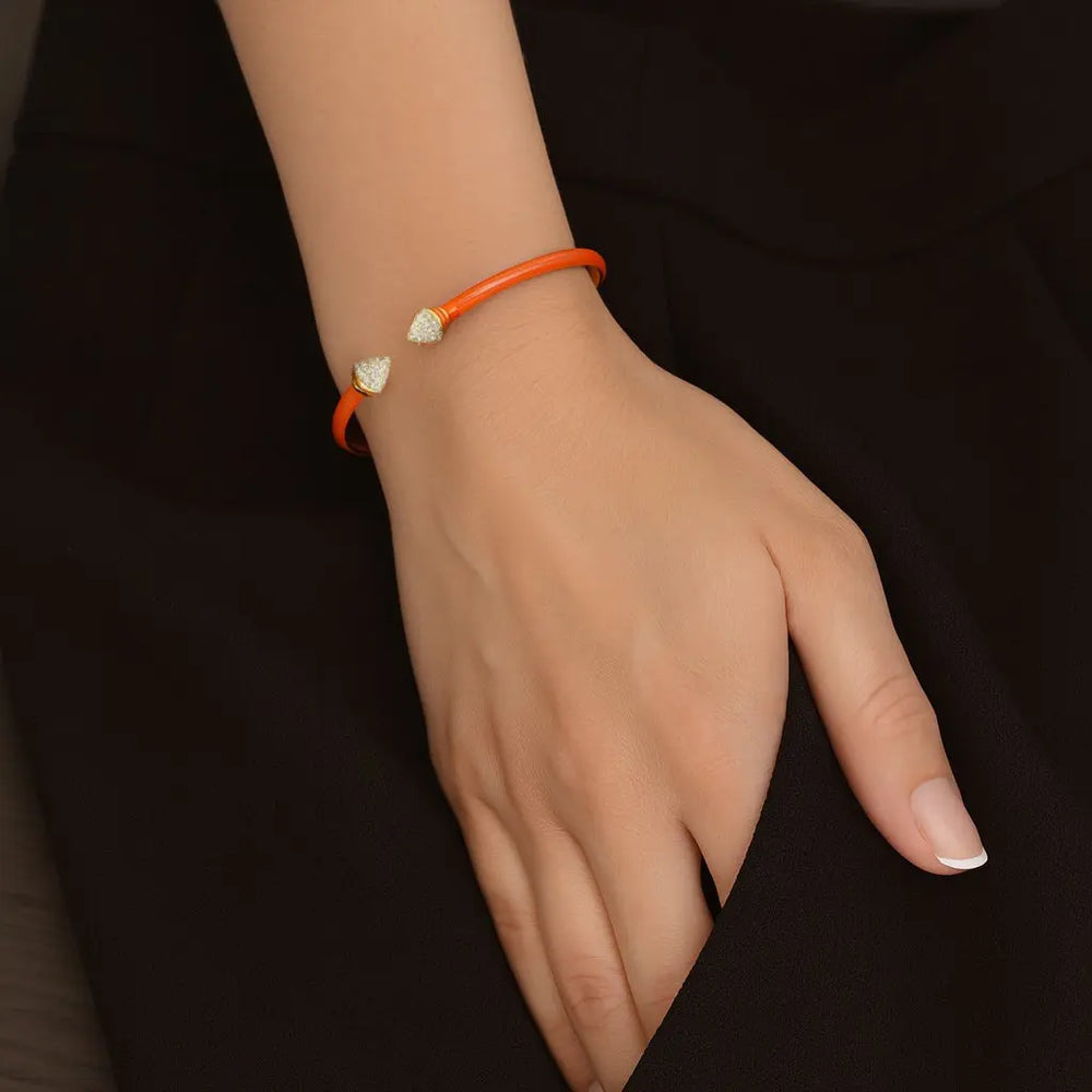 Goudkleurige armband met oranje emaille en zirkonia stenen  Victoria Valenza