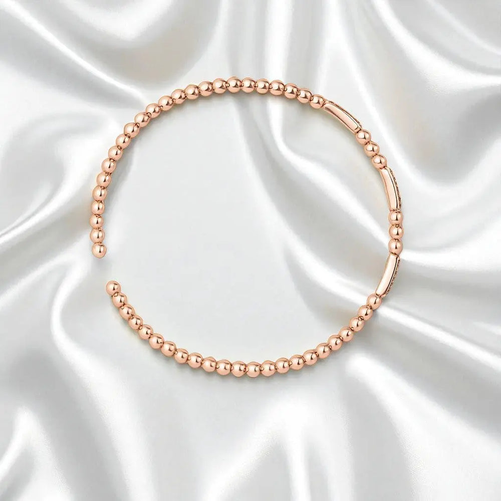 
                      
                        Roségoudkleurige bolletjes flexarmband met zirkonia stenen  Victoria Valenza
                      
                    