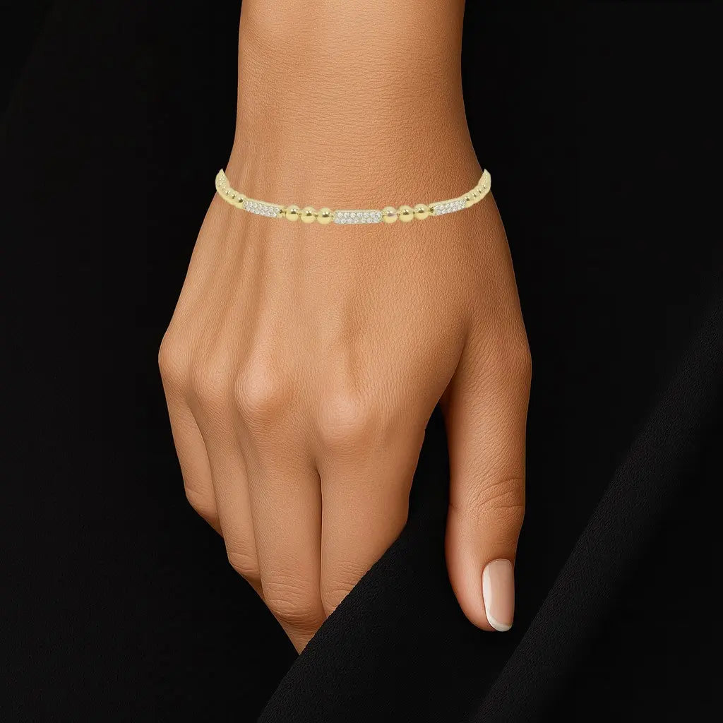 Goudkleurige bolletjes flexarmband met zirkonia stenen  Victoria Valenza
