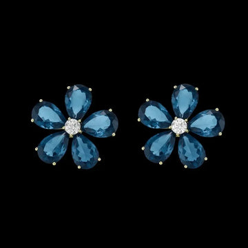 Goudkleurige bloem oorbellen met blauwe zirkonia stenen  Victoria Valenza