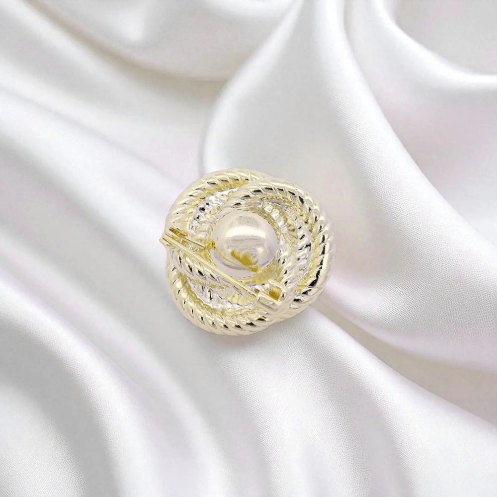 
                      
                        Goudkleurige knot broche met parel  Victoria Valenza
                      
                    