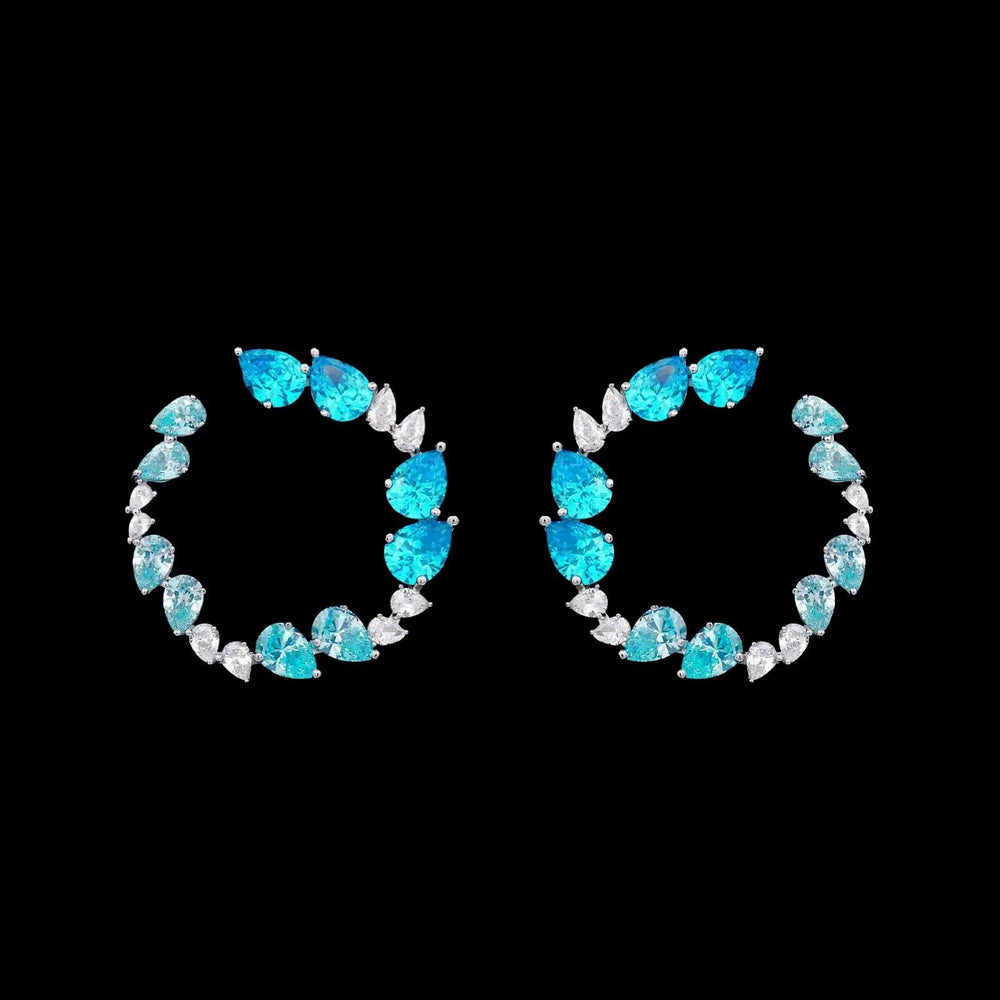 Zilveren fantasie cirkel oorbellen met turquoise zirkonia stenen  Victoria Valenza