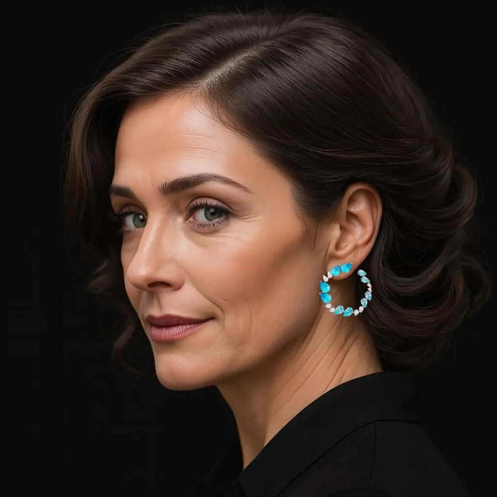 Zilveren fantasie cirkel oorbellen met turquoise zirkonia stenen  Victoria Valenza