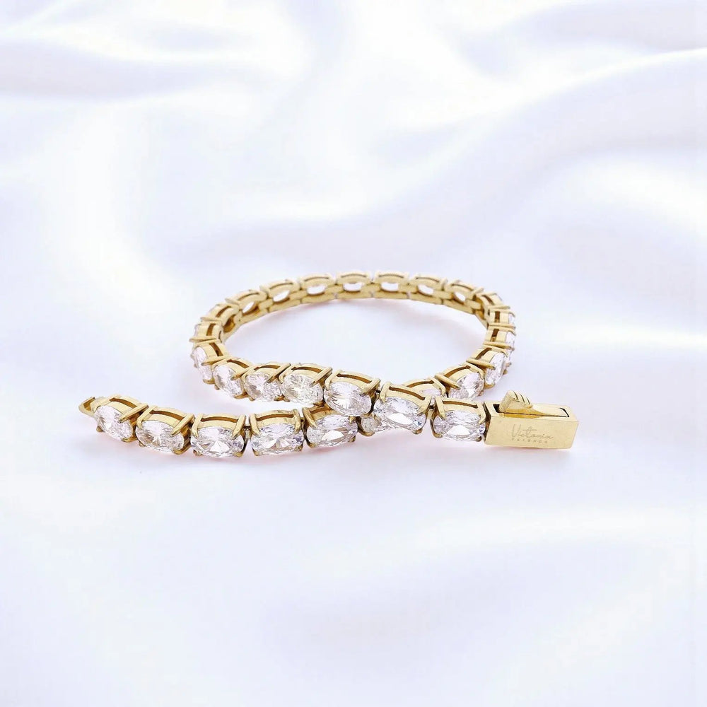 
                      
                        Goudkleurige RVS tennisarmband 18,3 cm met ovale zirkonia stenen  Victoria Valenza
                      
                    