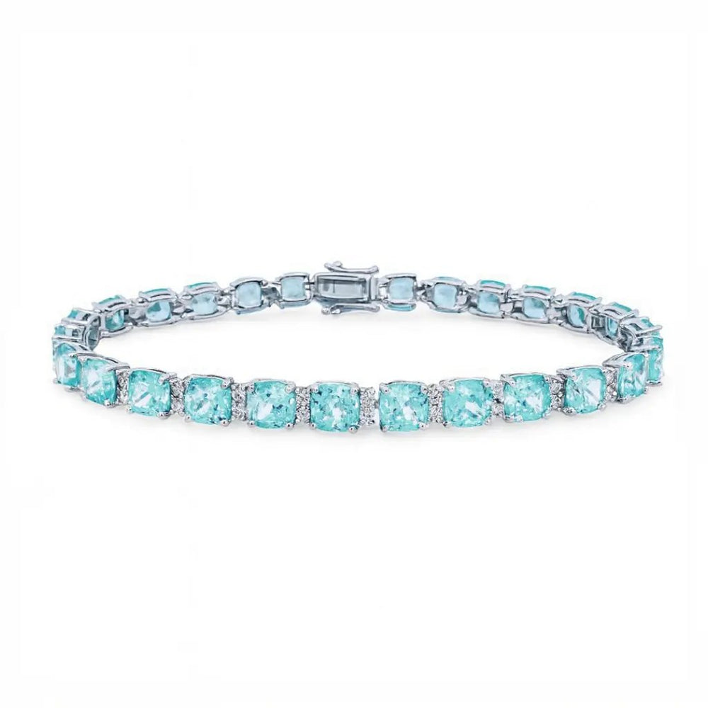 
                      
                        Zilveren armband met aquamarijnkleurige cushion zirkonia stenen  Victoria Valenza
                      
                    