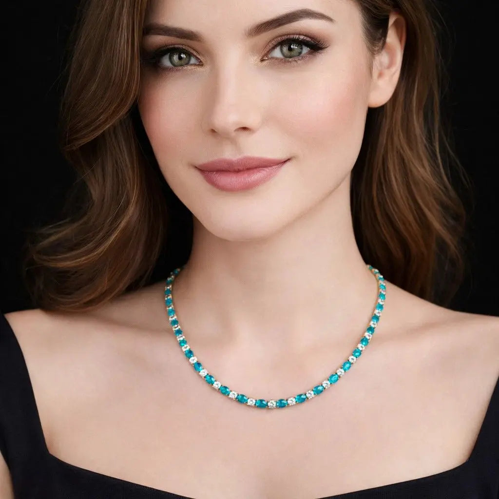 Goudkleurig RVS tenniscollier met ovale blauwe zirkonia stenen 4 mm