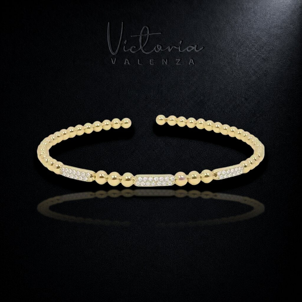 Goudkleurige Bolletjes Flexarmband met Zirkonia Stenen | Victoria Valenza