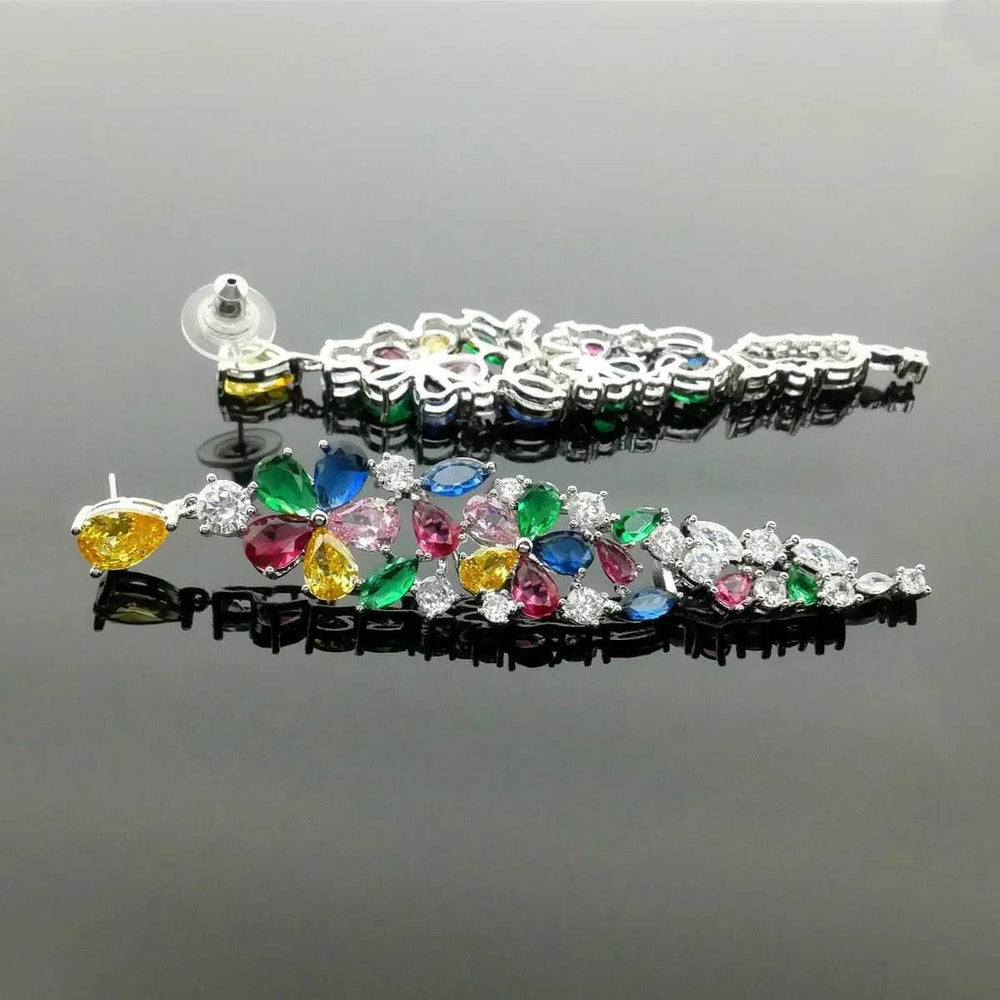 
                      
                        Zilverkleurige lange oorbellen met multicolor zirkonia stenen - Victoria Valenza
                      
                    