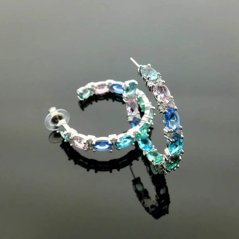
                      
                        Zilverkleurige creolen met multicolor zirkonia's - Victoria Valenza
                      
                    