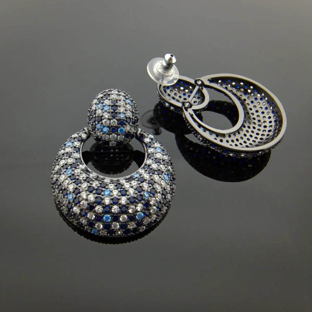 
                      
                        Ronde oorbellen met blauwe en witte zirkonia's - Victoria Valenza
                      
                    